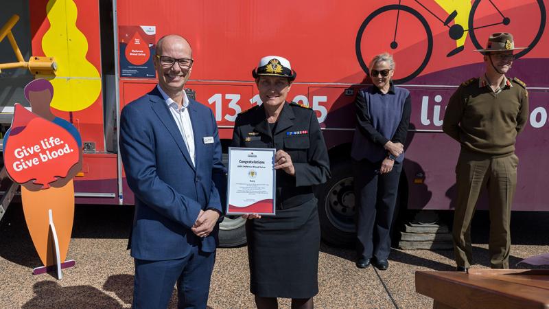 ADF Surgeon General Rear Admiral Sonya Bennett receives a certificate for last year’s Defence Blood Drive on behalf of Navy personnel at Blamey Square, Russell. 