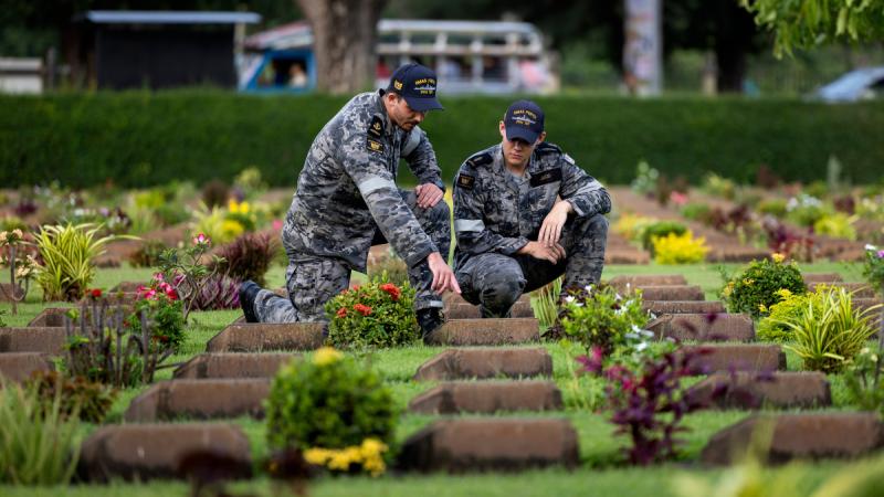 HMAS Perth's Leading Seaman Joshua Paynter, left, and Able Seaman Aidan Judd visit Kanchanaburi War Cemetery in Thailand during a regional presence deployment.