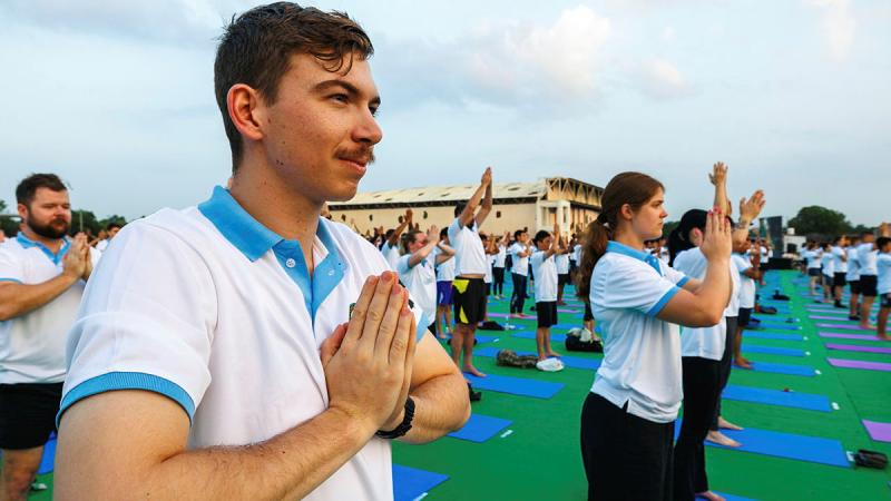 Aircraftman Tyler Brown participates in a yoga session on the flight line at Air Force Station Jodhpur, India, during Exercise Tarang Shakti 24.