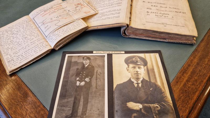 Photos of Lieutenant McWilliam, foreground right, and Captain McWilliam, foreground left; his diary, back left, and his midshipman’s journal, back right.