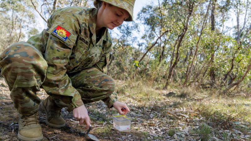 Army officer Captain Alison Mountain, from Unrecovered War Casualties - Army, tests some samples of soil in Canberra, ACT.