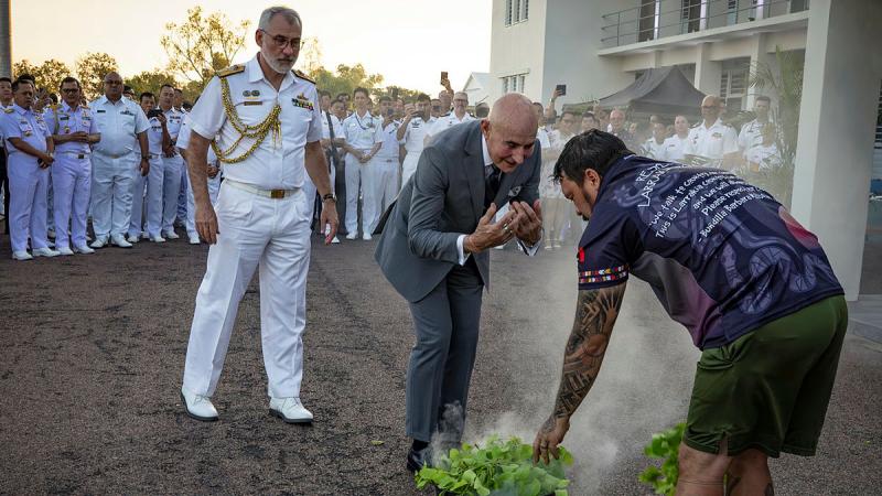 Royal Australian Navy Commander Australian Fleet Rear Admiral Chris Smith, and Professor Hugh Heggie, participate in a smoking ceremony with Larrakia man, Trent Lee, during the opening ceremony for Exercise Kakadu at HMAS Coonawarra, Darwin. 
