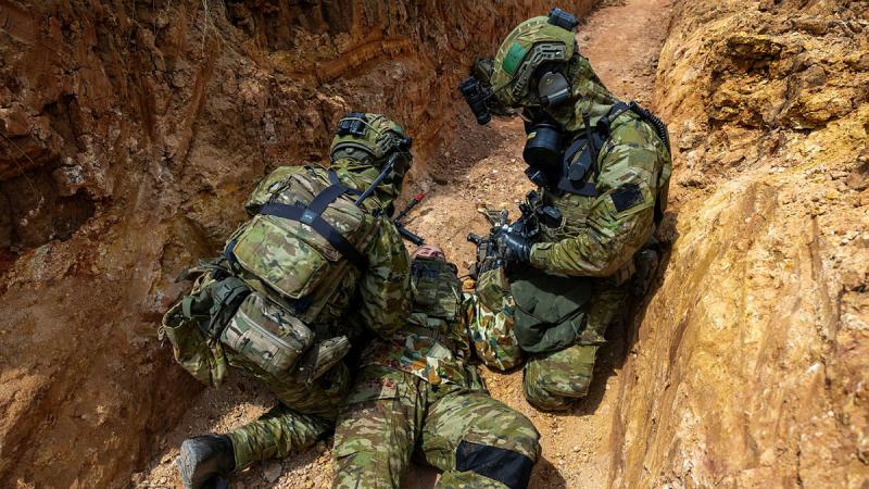 Army medics treat a simulated casualty during a trench warfare CBRN scenario as part of Exercise Rendezvous Acacia at the Wide Bay Training area, Queensland.