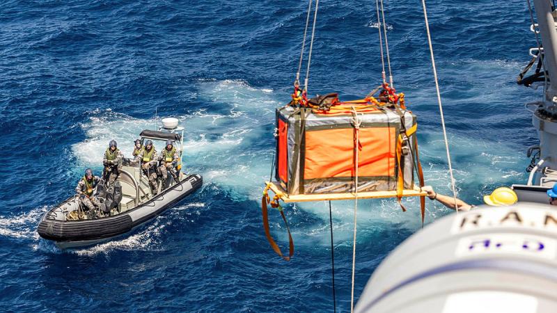  The stores dropped by the RAAF C-27J Spartan are craned onto HMAS Warramunga's deck during Exercise Kakadu 24.