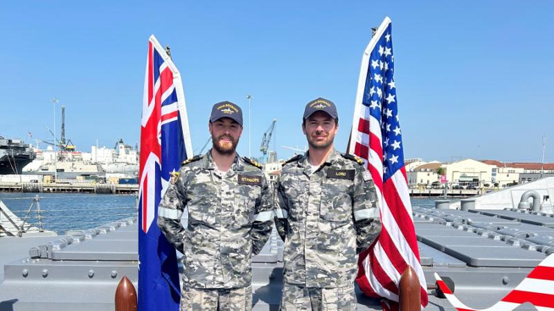 Lieutenant Jack Stanhope, left, and Sub-Lieutenant Liam Lord, of HMAS Brisbane, render assistance to a civilian following a motor-vehicle accident in the US.