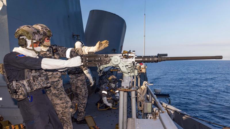 Japan Maritime Self-Defense Force's Rear Admiral Kazushi Yokota, Commander, Escort Flotilla 3, fires the .50 calibre machine gun on board HMAS Warramunga during Exercise Kakadu 24. 