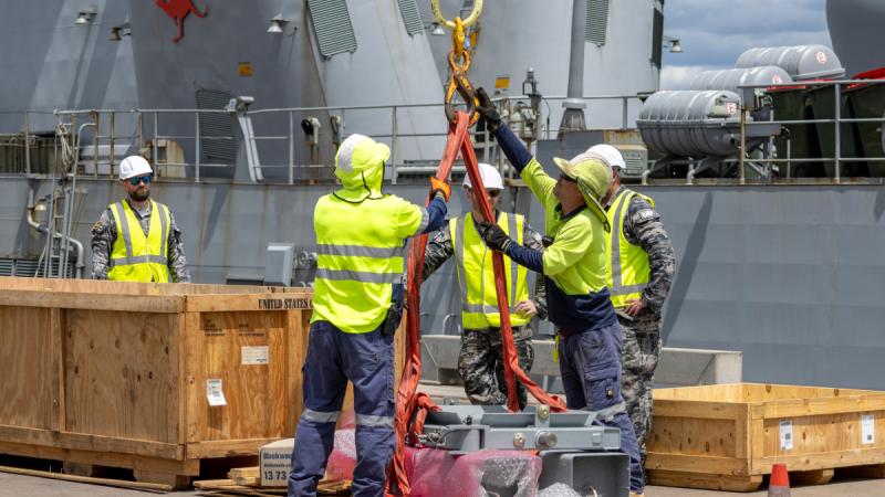Support staff from Thales Australia, Port of Darwin and the ADF assist in the reammunitioning of HMAS Warramunga's Vertical Launching System in Darwin, Northern Territory.