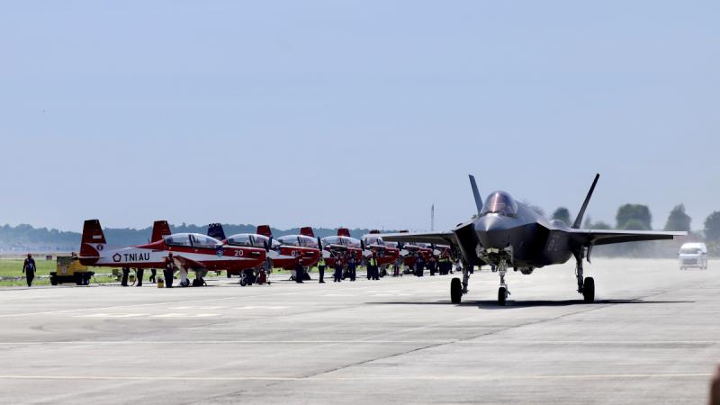 An RAAF F-35A Lightning II taxis past the Indonesian Air Force Jupiter Aerobatic Team at the Bali International Air Show 2024.