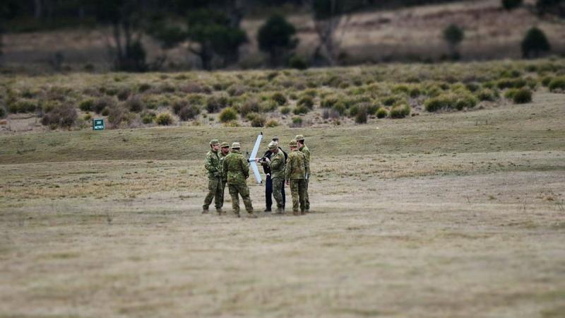 Australian Army soldiers gather round the instructor during the train-the-trainer course at Buckland training area in Tasmania. 