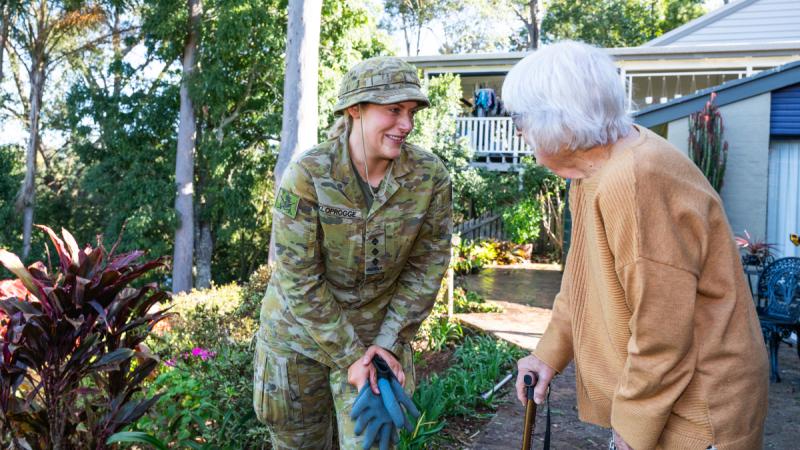 Army officer Captain Rachael Kloprogge from Headquarters 6th Brigade greets Legacy widow and former Signaller Shirley Ross during a Legacy Brisbane Backyard Assist at Mrs Ross’ home in Chapel Hill, Brisbane.