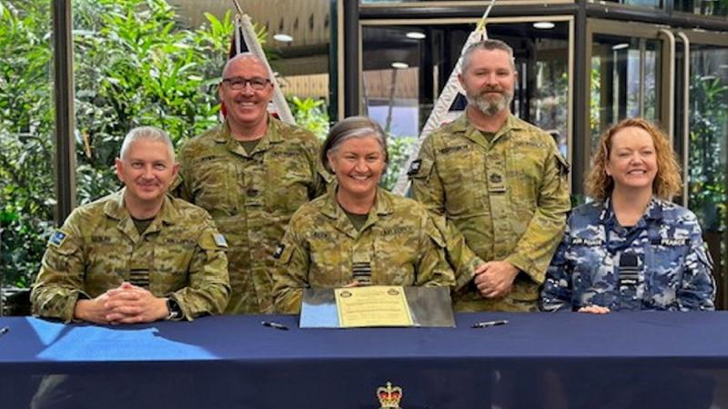 Group Captain Gary Sadler, Warrant Officer Jason Pyke, Group Captain Kylie Green, Warrant Officer Korey McGregor and Wing Commander Fiona Pearce following the 17 Squadron handover/takeover ceremony.