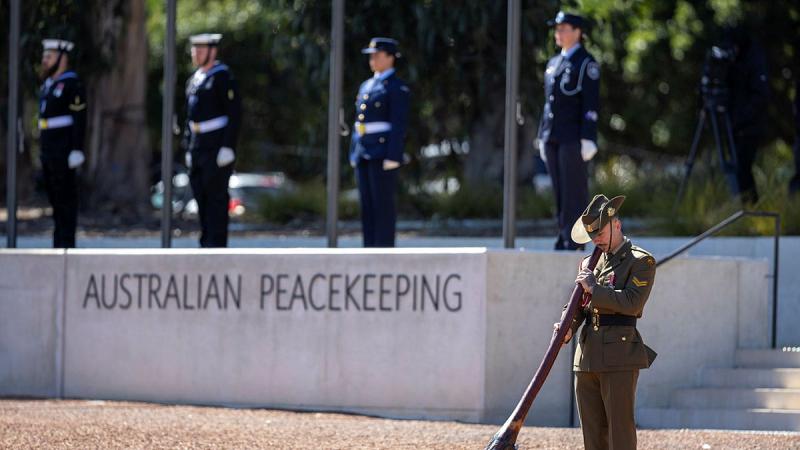 ADF members, including an Army didgeridoo player, take part in the national ceremony in Canberra to mark the 25th anniversary of Australian service in East Timor. 