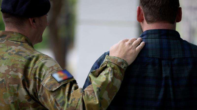 An ADF member and civilian in conversation.