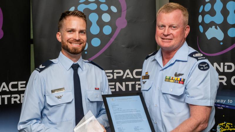 Corporal Ryan Hodson, left, receives The Corporal Margaret Clarke Award from Warrant Officer of the Air Force Ralph Clifton at an awards ceremony held at Russell Offices, ACT. 