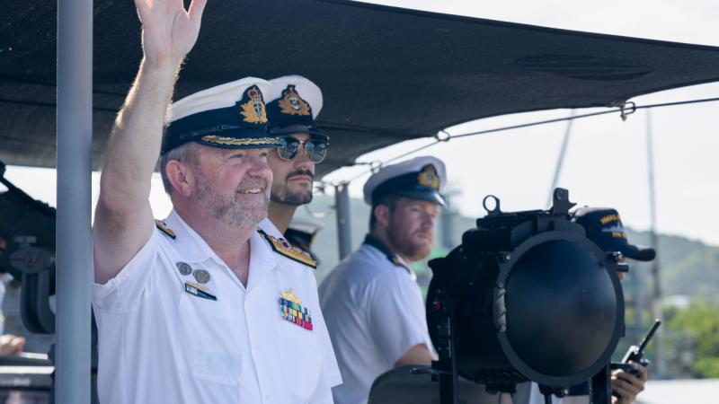 Commander Indo-Pacific Endeavour 2024 Commodore Michael Harris waves as HMAS Perth berths alongside Sattahip Naval Base Dockyard in Chon Buri, Thailand.