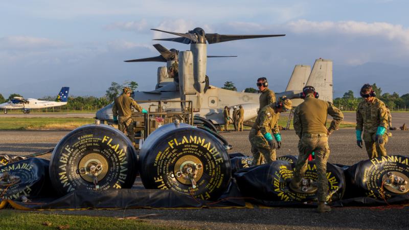 Australian Army soldiers refuel a US Marine Corps MV-22 Osprey at a refuelling point aviation during Operation Render Safe, Honiara, Solomon Islands.