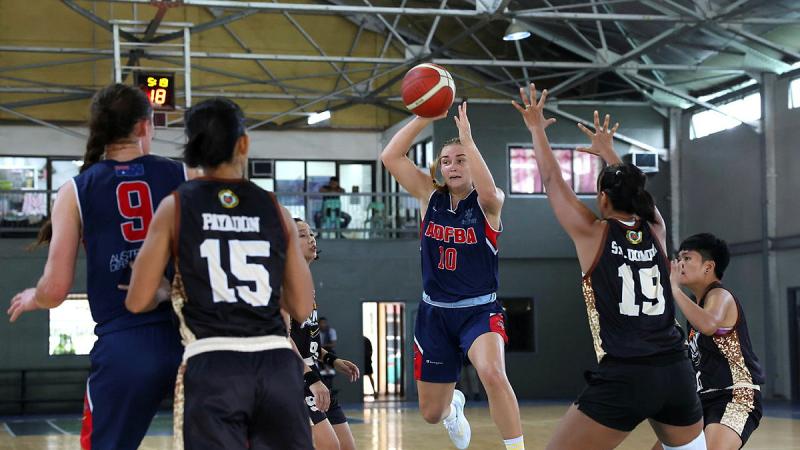 Leading Aircraftwoman Courtney Allibon passes the ball during a basketball game against an Armed Forces of Philippines side during Indo-Pacific Endeavour at Camp Aguinaldo, Philippines. 