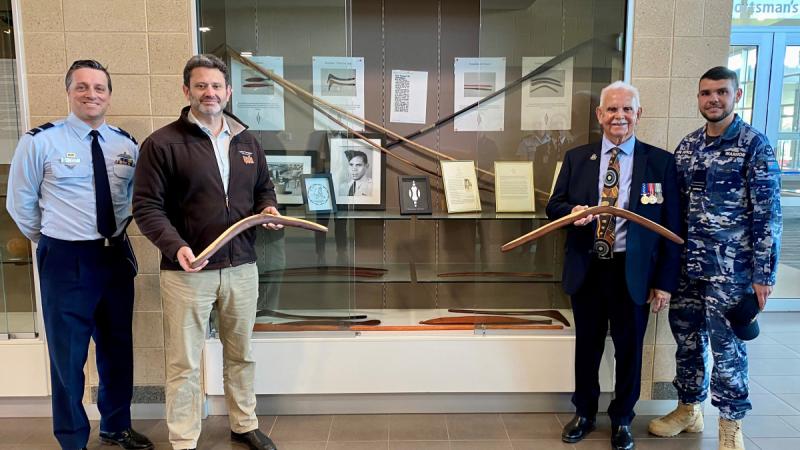 Commander Air Warfare Centre Air Commodore Adrian Maso, left, and Flight Lieutenant Steve Warrior, right, give South Australian Aboriginal Affairs Minister Kyam Maher, centre left, and Chair of Aboriginal Veterans South Australia Frank Lampard, centre right, access to the Indigenous artefacts cabinet at RAAF Base Edinburgh.