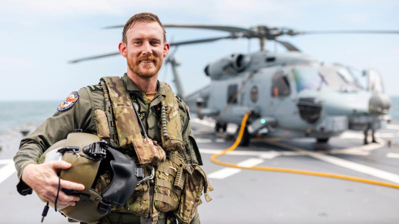 Aircrewman Leading Seaman James Neville on the flight deck as HMAS Sydney’s embarked MH-60R helicopter “Phoenix” prepares for flying operations as the ship is deployed on Operation Argos.