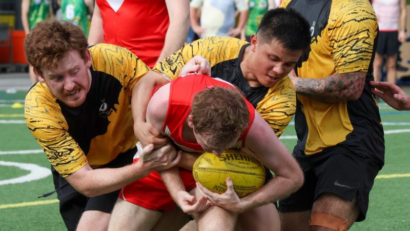 HMAS Perth crew participate in an AFL game with members of Singapore Cricket Club at the Dempsey Field during the ship’s visit to Sembawang, Singapore, as part of a regional presence deployment. 