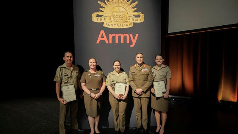 The Chief of Army, Lieutenant General Simon Stuart, and the Regimental Sergeant Major-Army, Warrant Officer Kim Felmingham, with the winners of the Army Storytelling Competition 2024. From left, Corporals Lee Philp and Kyra Cain, and Sapper Veronica Bonnar in Melbourne, Victoria. 