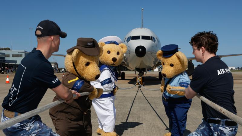 The Legacy bears pose with 24 Squadron team members prior to the P-8A aircraft pull at RAAF Base Edinburgh, South Australia.