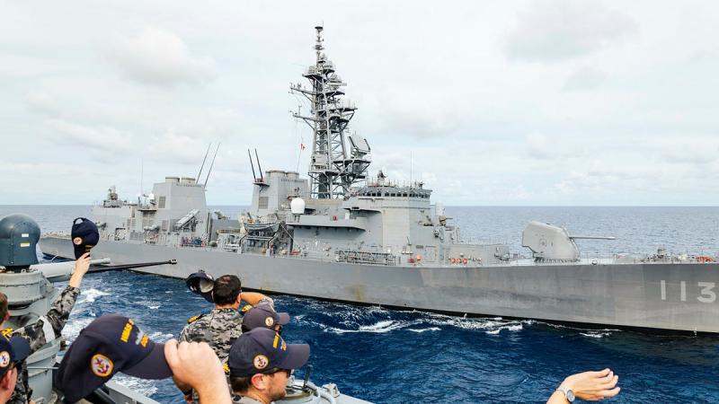 HMAS Sydney’s bridge team wave towards Japan Maritime Self-Defense Force ship JS Sazanami during a formation foxtrot as part of a regional presence deployment. 