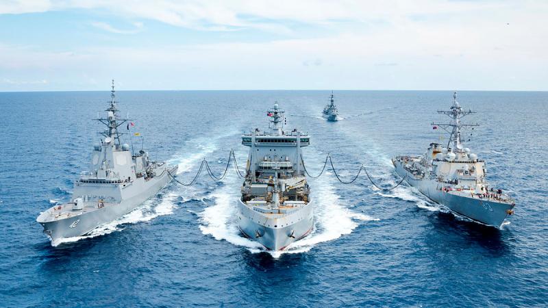 Japan Maritime Self-Defense Force ship JS Sazanami sails behind Royal New Zealand Navy ship HMNZS Aotearoa, centre, while conducting a dual replenishment at sea with HMAS Sydney, left, and USS Howard, right, during a maritime cooperative activity in the South China Sea.