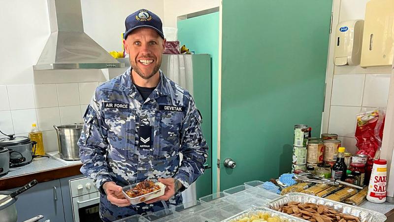 Air Force Chef Corporal Brent Devetak prepares meals for locals at Kununurra during Exercise Kummundoo 24. 