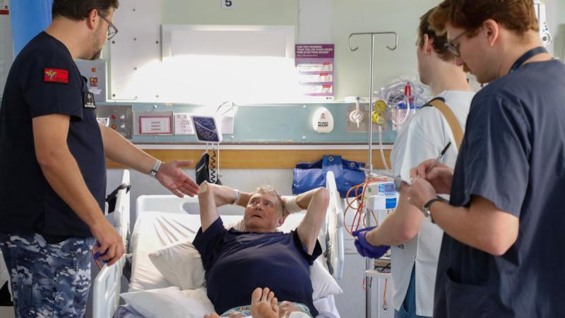 Air Force General Surgeon Squadron Leader Peter Yuide from No. 1 Expeditionary Health Squadron discusses treatment options with Steve, a local patient in the Katherine Hospital.