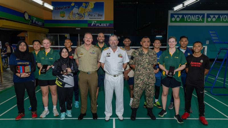 Commander Indo-Pacific Endeavour 2024 Commodore Michael Harris, centre, and SO1 Malaysia-Australia Joint Defence Program Lieutenant Colonel Bradley Smith, centre left, with Badminton teams from the ADF and Malaysian Armed Forces in Kuala Lumpur, Malaysia.