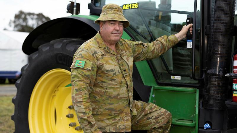 Australian Army driver Corporal Clifford Ball from Sydney University Regiment has a look at a local farmer's tractor during the Murrumbateman Field Days, October 19-20. 