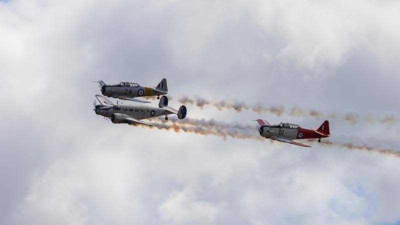 A civilian Beechcraft D18S and two civilian T-6 Harvards fly in formation at Warbirds Downunder in Temora, NSW.