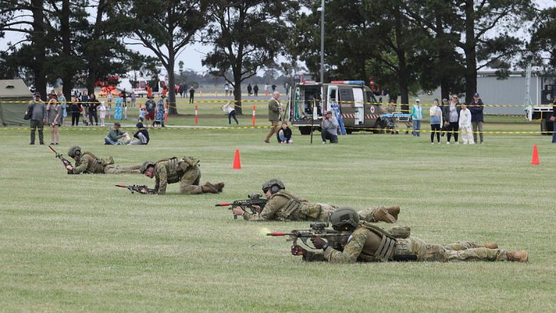 Members of the Officer Training School conduct a simulated section attack for the visiting public during the RAAF Base East Sale open day.