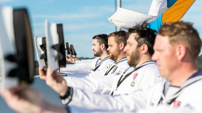 HMAS Hobart’s ship's company cheer ship as Their Majesties King Charles III and Queen Camilla pass during a Royal Australian Navy Fleet Review in Sydney Harbour. 
