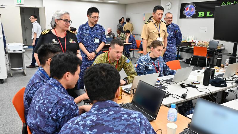 Captain Gordon observing team 3 with Leading Aircraftman Shumack 
