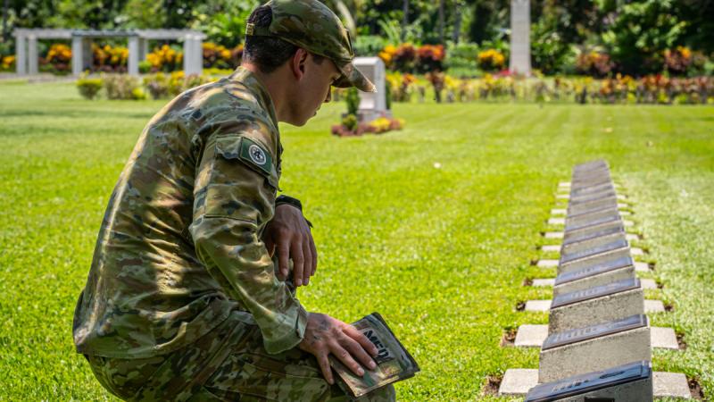 Jonathan Church Good Soldiering Award recipient Lance Corporal Lachlan Goulding pays respect to the grave of medical officer Captain Brian Pokely at the Bita Paka war cemetery, PNG.