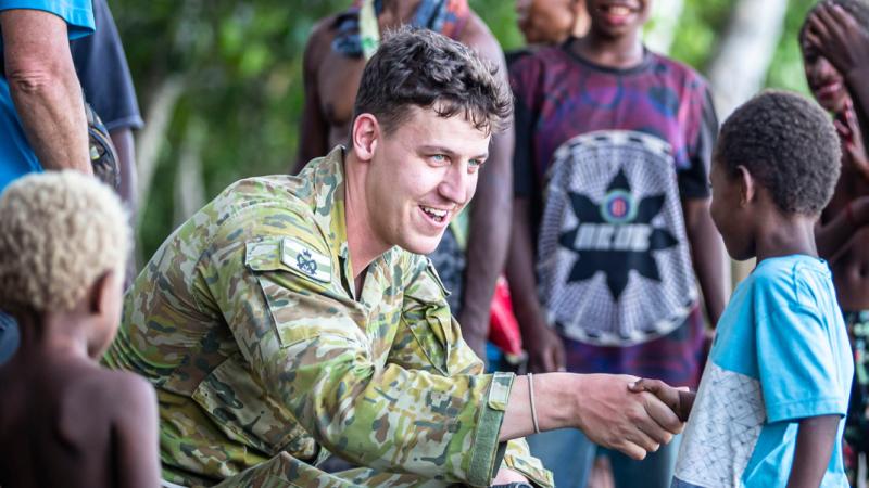 Lieutenant Lachlan Maill meets local villagers in Rabaul, PNG, during a historical battle tour.