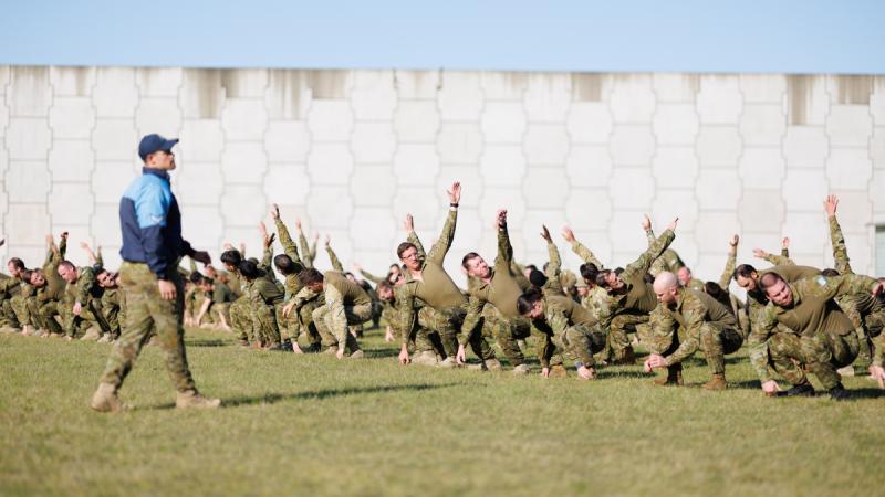 Air Force aviators take part in a warmup session in readiness to participate in the Combat Support Group Charity Group Workout at RAAF Base Williamtown, NSW.
