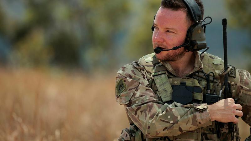 Royal Air Force Joint Terminal Attack Controller Sergeant Craig Clarke changes his radio's frequency during live fire serials as part of Exercise Black Dagger 2024. 