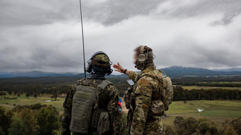 A Philippine Air Force member works with a RAAF combat controller during Exercise Havoc Strike at Bulahdelah near RAAF Base Williamtown, NSW. Image has been modified for security.