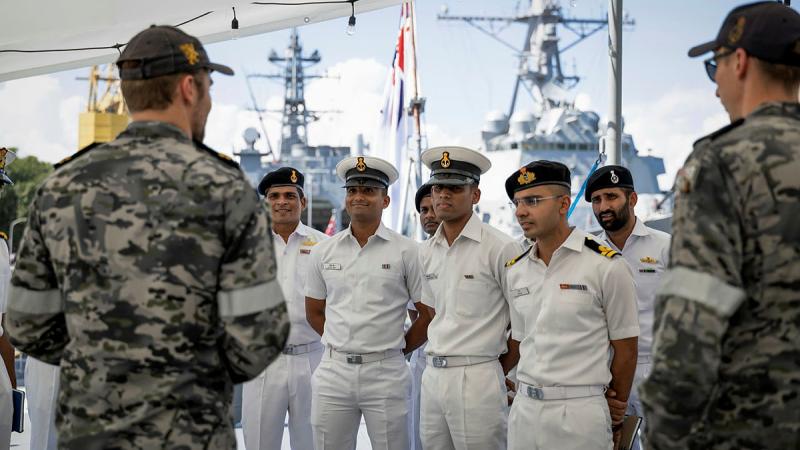 Indian Navy sailors and officers with Royal Australian Navy sailors on the flight deck of HMAS Stuart during a tour while alongside in Visakhapatnam, India as part of Exercise Malabar. 