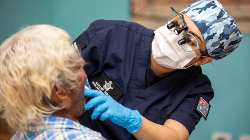 Air Force dental officer Flight Lieutenant Maryam Ferooz performs a dental examination of a resident of the Juniper Gerdewoonem Aged Care Facility at Kununurra during Exercise Kummundoo 24. 