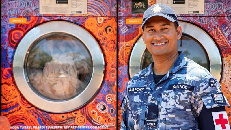 Air Force Environmental Health Officer Flying Officer Rayneil Shandil at the Orange Sky mobile laundry truck in Kununurra during Exercise Kummundoo 24.