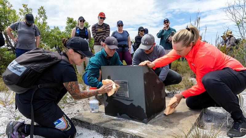 Members of Air Combat Electronic Attack Systems Program Office clean the memorial site for the lost aircrew of a downed F-111C during a team building activity held at Bundjalung National Park, Queensland. 