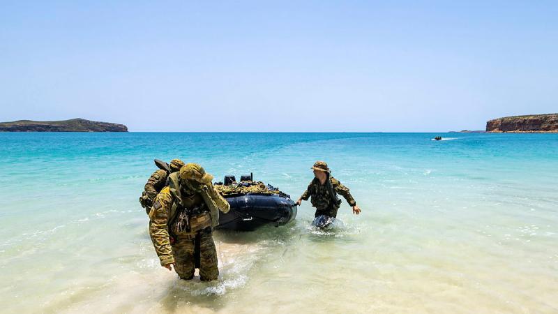 Private Justin Kennedy, left, and NORFORCE personnel pull a Zodiac boat ashore during a surveillance and reconnaissance patrol of the northern Kimberley coast of Western Australia. 