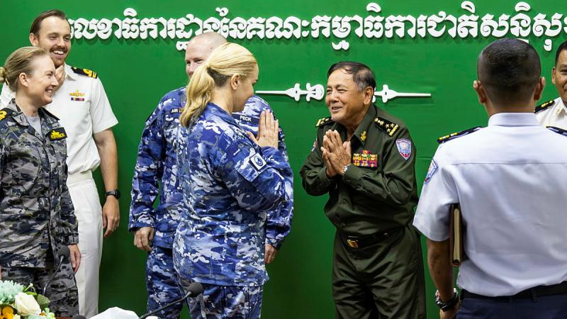 RAAF Group Captain Lesley Carney and General Seng Vanthy from the Royal Cambodian Navy greet each other during Indo-Pacific Endeavour. 