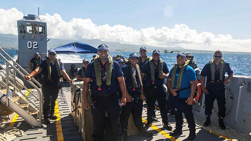 Police officers return to HMAS Choules on the ship's landing craft after their shift in Apia, Samoa. 