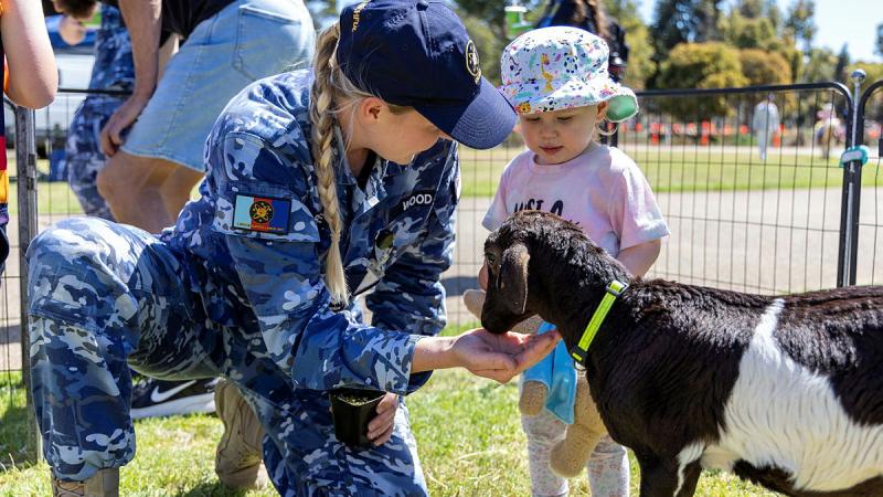Corporal Rebecca Wood from 1 Space Surveillance Unit enjoys the farm animals with her daughter at the Edinburgh Formation Welfare Family Day at RAAF Base Edinburgh, SA. 