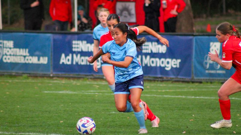 Air Force player Corporal Olivia Tannock plays the ball against the Army team at the ADF Football Federation National Championships in Glenwood, NSW.